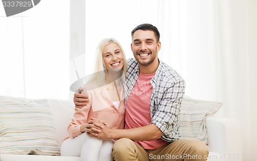 Image of smiling happy couple at home