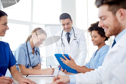 Image of group of happy doctors meeting at hospital office