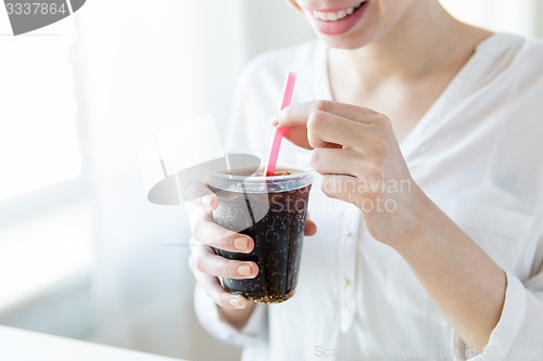 Image of close up of happy woman drinking coca cola