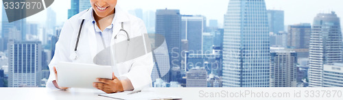 Image of happy african female doctor with tablet pc