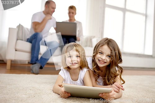 Image of happy little girls with tablet pc computer at home