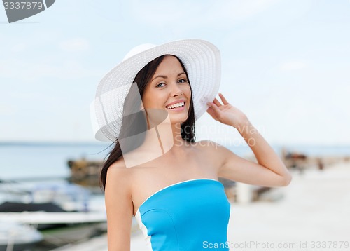 Image of girl in hat standing on the beach