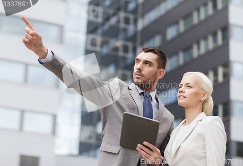 Image of serious businessmen with tablet pc outdoors