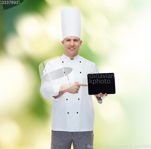 Image of happy male chef cook showing with tablet pc
