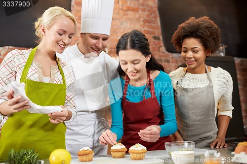 Image of happy women and chef cook baking in kitchen