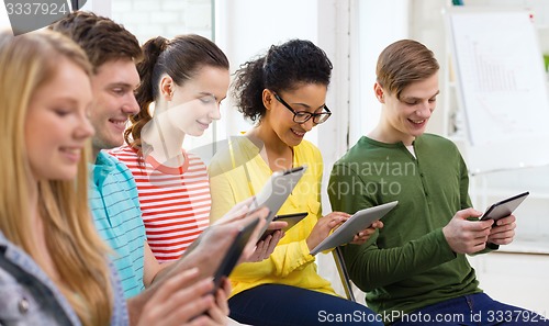 Image of smiling students with tablet pc at school