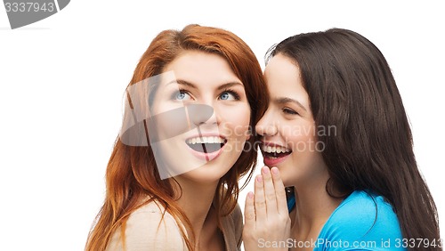 Image of one girl telling another secret