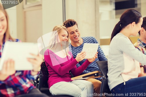 Image of group of smiling students with tablet pc