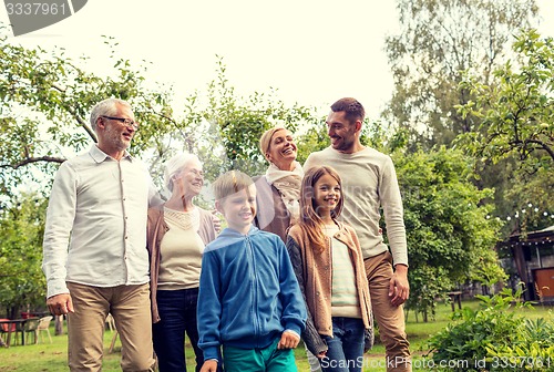 Image of happy family in front of house outdoors