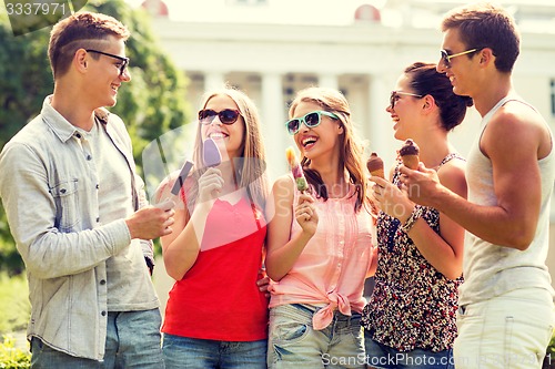 Image of group of smiling friends with ice cream outdoors