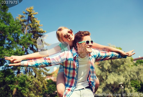 Image of smiling couple having fun in park