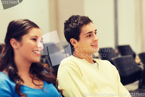 Image of group of smiling students in lecture hall