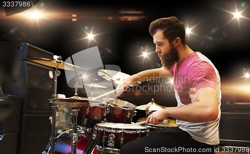 Image of male musician playing cymbals at music concert