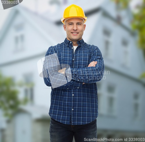 Image of smiling male builder or manual worker in helmet