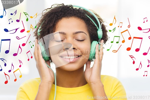 Image of happy woman with headphones listening to music