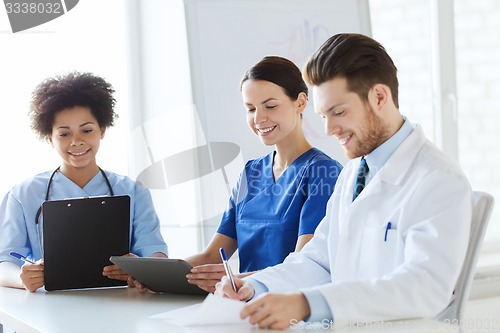 Image of group of happy doctors meeting at hospital office