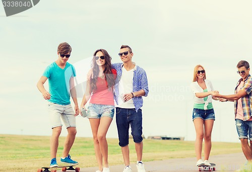 Image of group of smiling teenagers with skateboards