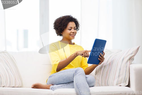 Image of happy african american woman with tablet pc