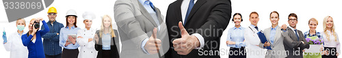 Image of businessman and businesswoman showing thumbs up
