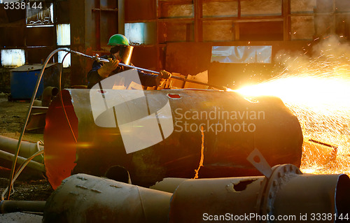 Image of worker using torch cutter 