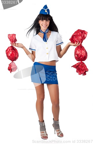 Image of Young beautiful air hostess with 2 big candies