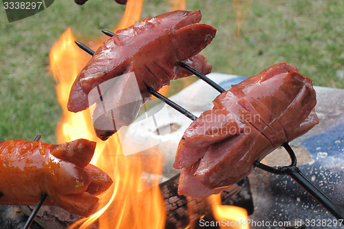 Image of bratwurst preparing on the fire