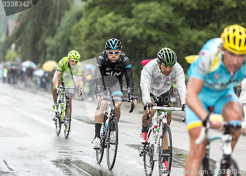 Image of Group of Cyclists Riding in the Rain - Tour de France 2014