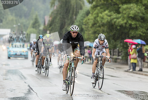 Image of The Peloton Riding in the Rain - Tour de France 2014