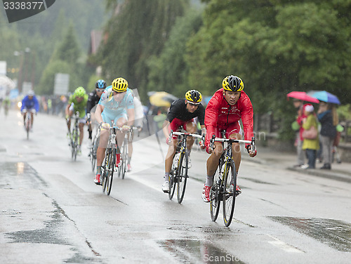 Image of The Peloton Riding in the Rain - Tour de France 2014