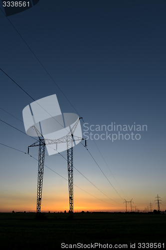 Image of Large transmission towers at sunset