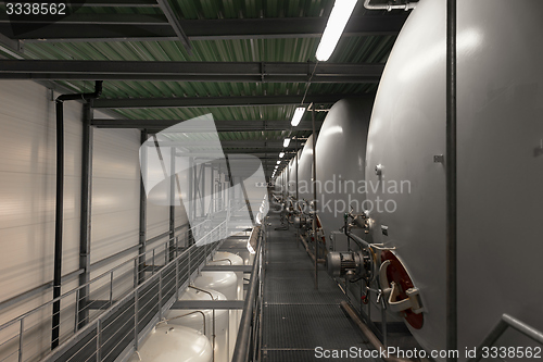 Image of Large industrial white silos in modern factory