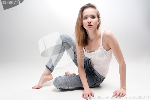 Image of Attractive sad woman on floor