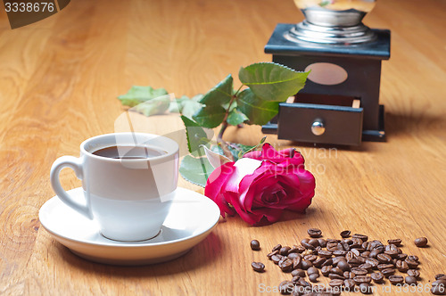 Image of Vintage coffee mill, cup and rose
