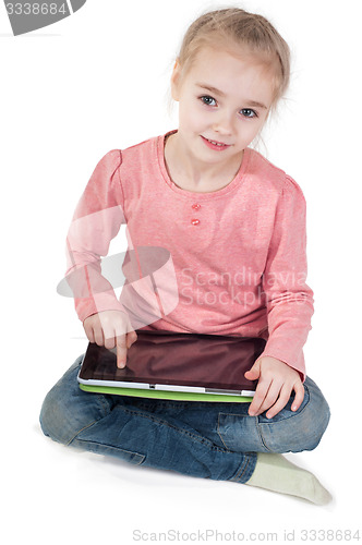 Image of Little girl uses a tablet PC