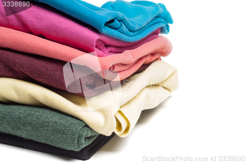 Image of Closeup of pile of folded T shirts