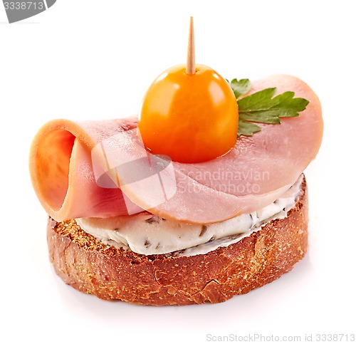 Image of toasted bread slice with ham and tomato