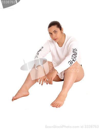 Image of Woman in white dress sitting on floor.