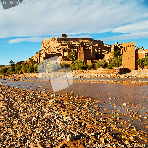 Image of sunset in africa old construction near the river blue