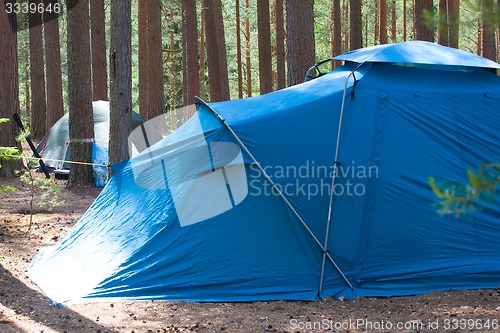 Image of camping outdoor with  tent in woods in summer 