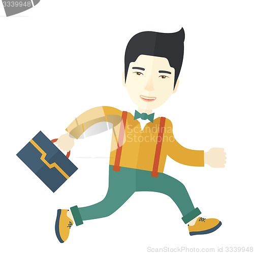 Image of  Chinese Buisnessman walking with his briefcase.