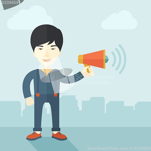 Image of Businessman in the field holding a megaphone.