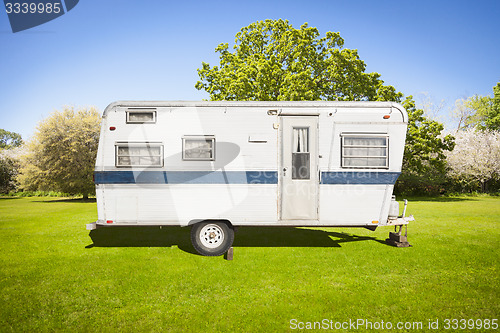 Image of Classic Old Camper Trailer In Grass Field