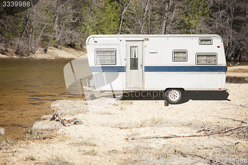 Image of Classic Old Camper Trailer Near A River