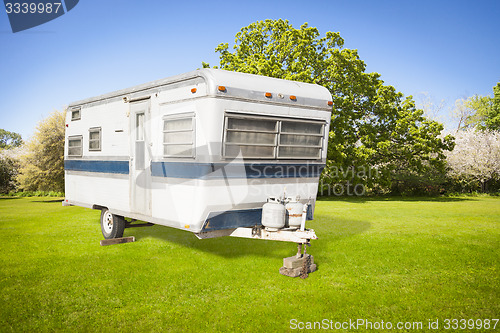 Image of Classic Old Camper Trailer In Grass Field