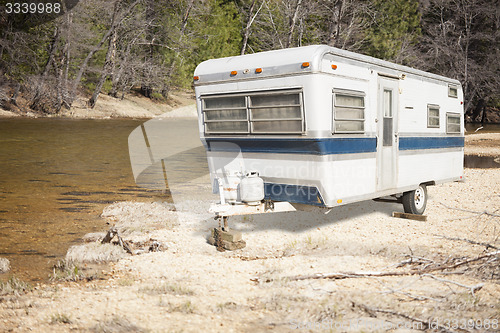 Image of Classic Old Camper Trailer Near A River