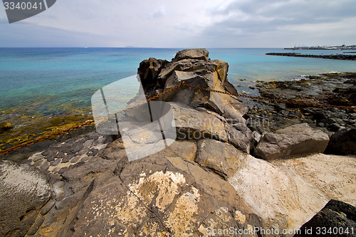 Image of pier rusty chain  water  boat   and summer lanzarote spain