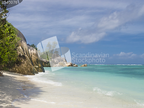 Image of Pristine tropical beach surrounded by granite boulders