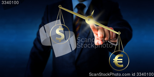 Image of Euro Sign Outweighing The Dollar On Golden Scale