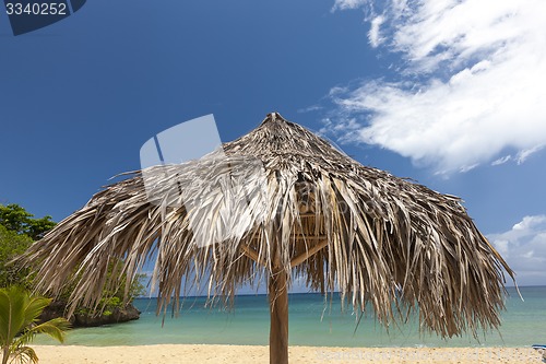 Image of straw umbrella on a tropical beach