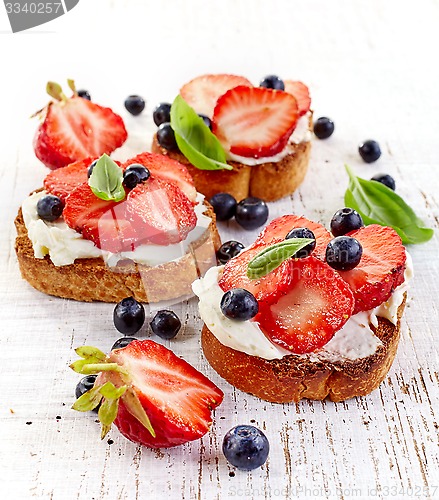 Image of toasted bread with cream cheese and strawberries